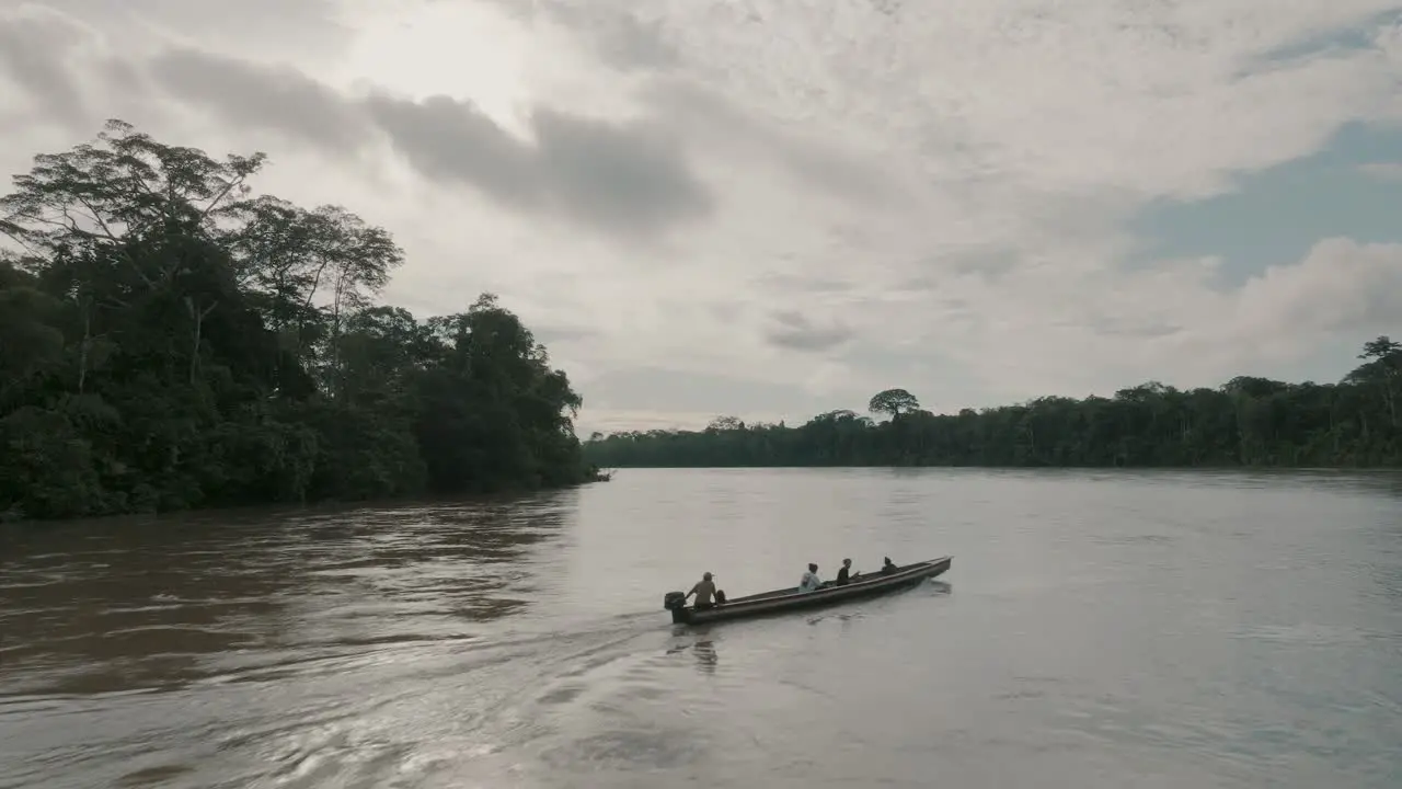 Aerial shot of passenger boat travelling on the Amazon river between the dense forest