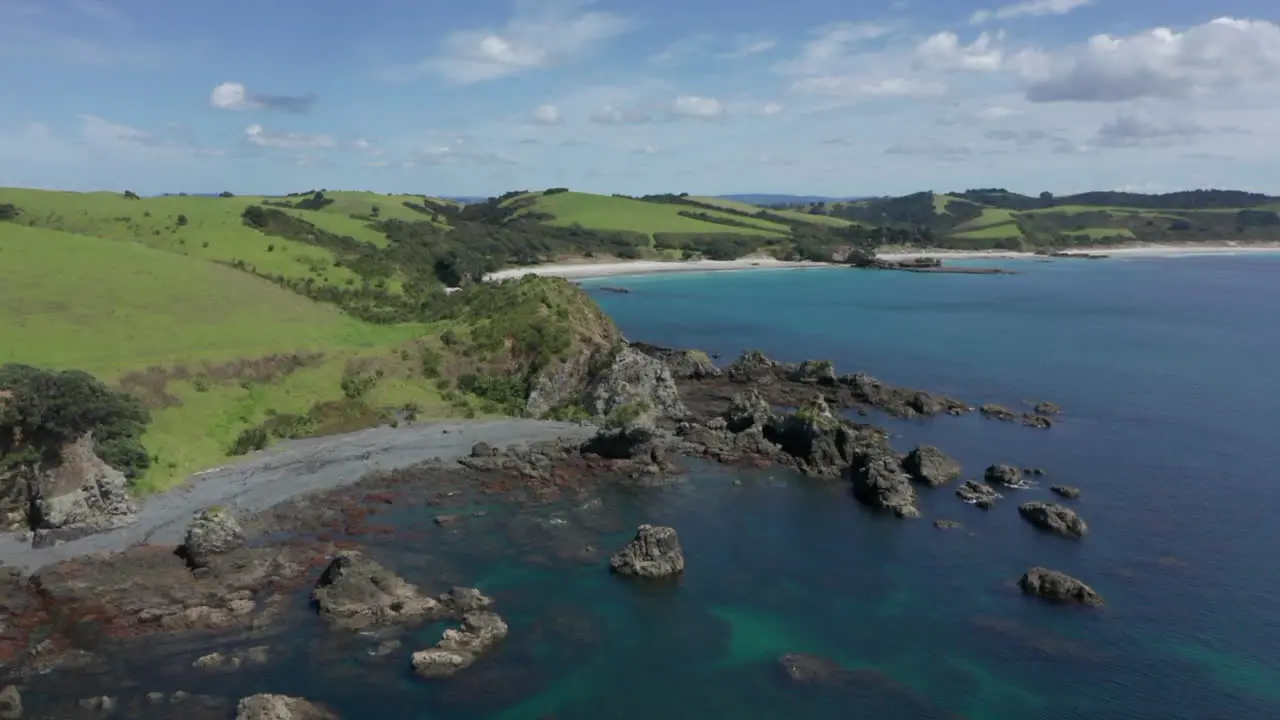 The Beautiful Island Of Tawharanui Regional Park in New Zealand With Calm Ocean and Bright Blue Sky Above Aerial Shot