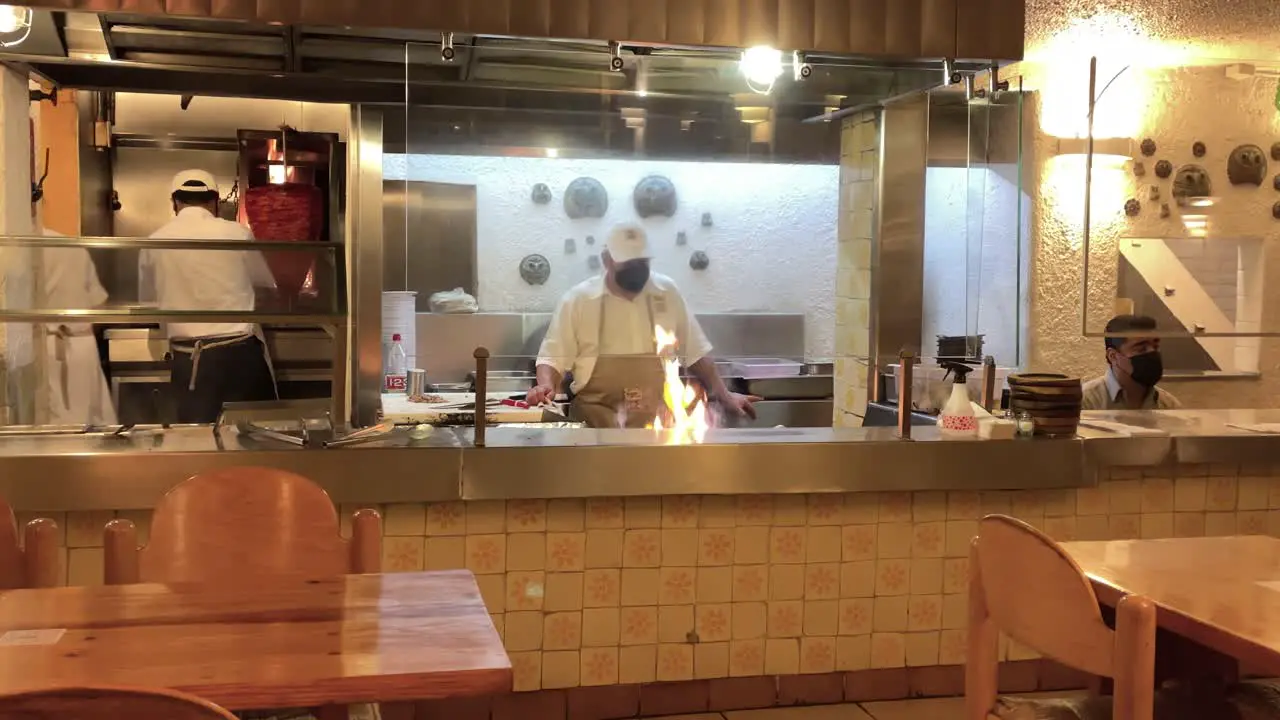 slow motion shot of waiter preparing taco plates in mexico city