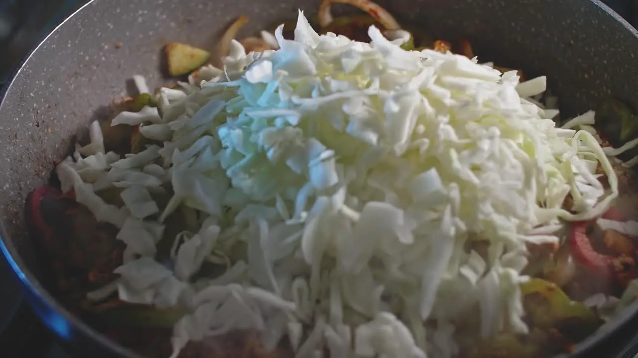 Cooking ingredients for homemade mexican food in a wok close up view