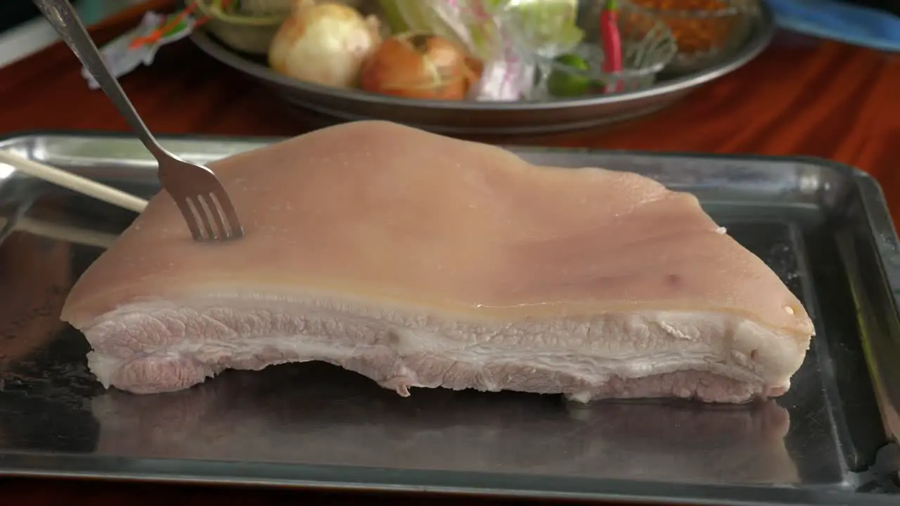 Boiled pork belly meat being prepared in Thailand cuisine style