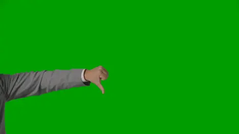 Close Up Of Arm Of Businessman In Suit Choosing Between Thumbs Down And Down Gesture Against Green Screen 