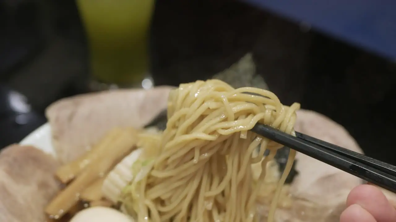 man use chocpstick pick ramen japanese noodle ready to eat