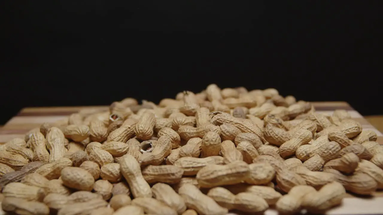 Spinning pile of peanuts on cutting board wide angle on a cutting board