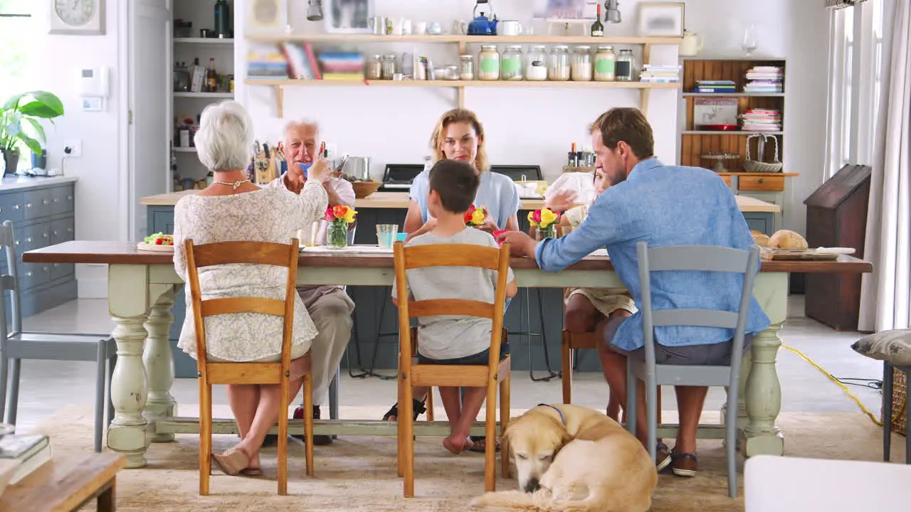 Three generation family eating at the kitchen table at home