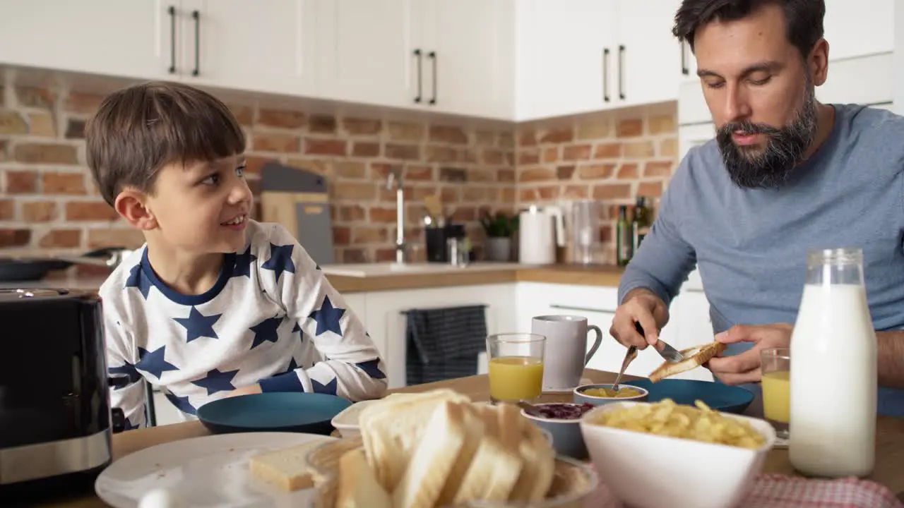 Video of father and son having breakfast together at the mornin