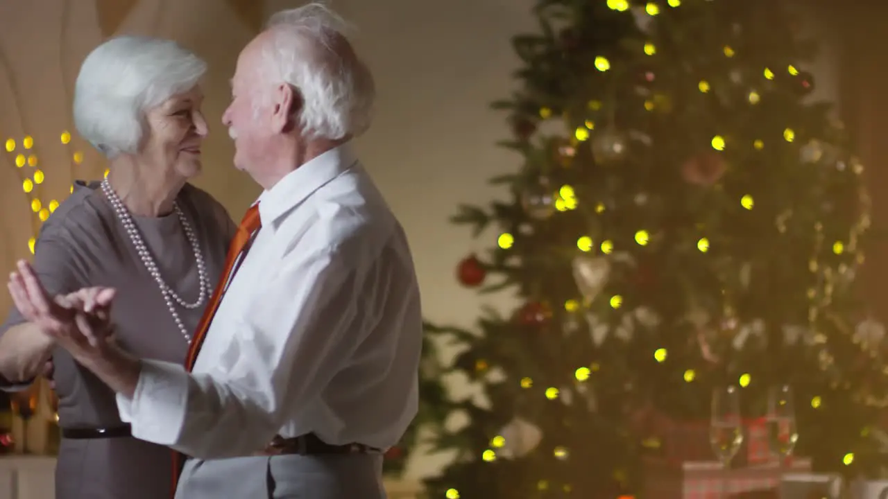 Loving Senior Couple Dancing Togheter At Home On Christmas