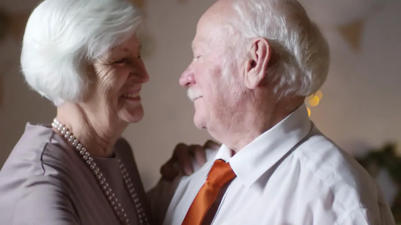 Portrait Of A Loving Senior Couple Dancing Togheter At Home On Christmas