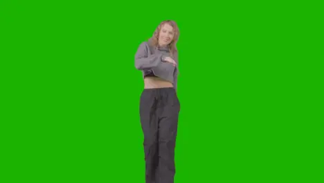 Full Length Studio Shot Of Young Woman Having Fun Dancing Against Green Screen 3