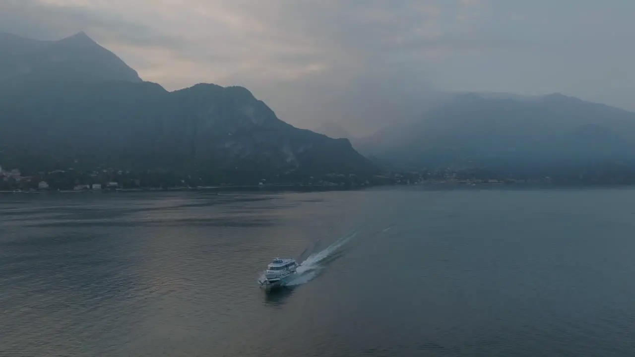 4K Aerial Sunset shot of hydrofoil arriving in Bellagio Lake Como Italy