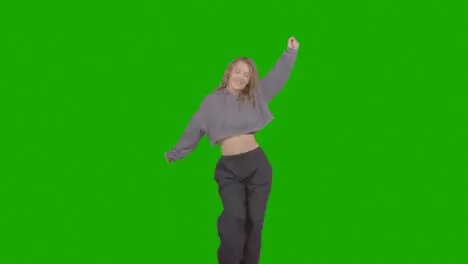 Studio Shot Of Young Woman Having Fun Dancing Against Green Screen 26