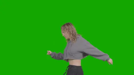 Studio Shot Of Young Woman Having Fun Dancing Against Green Screen 13