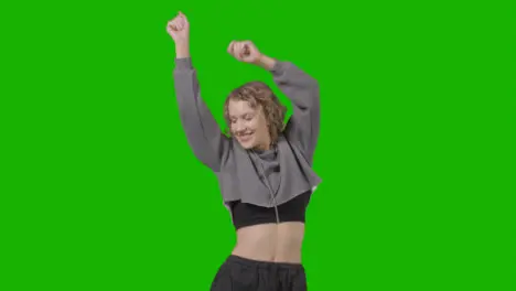 Studio Shot Of Young Woman Having Fun Dancing Against Green Screen 21