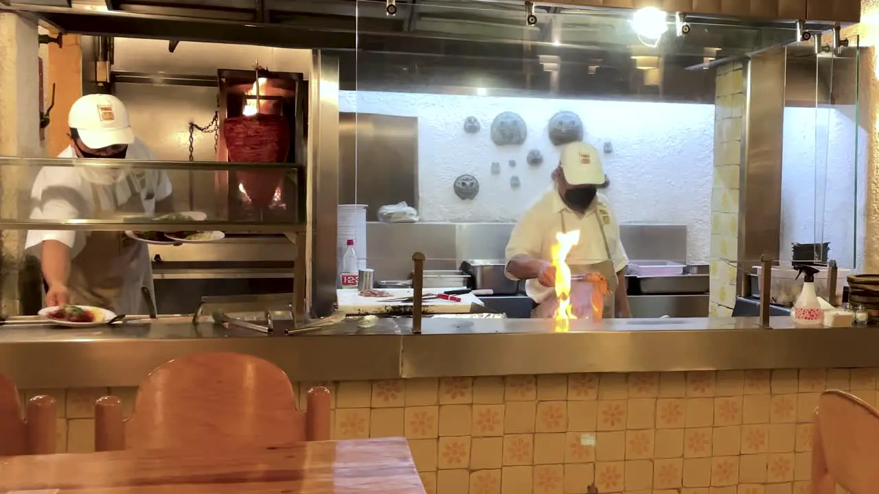 slow motion shot of waiter serving plates of tacos in mexico city