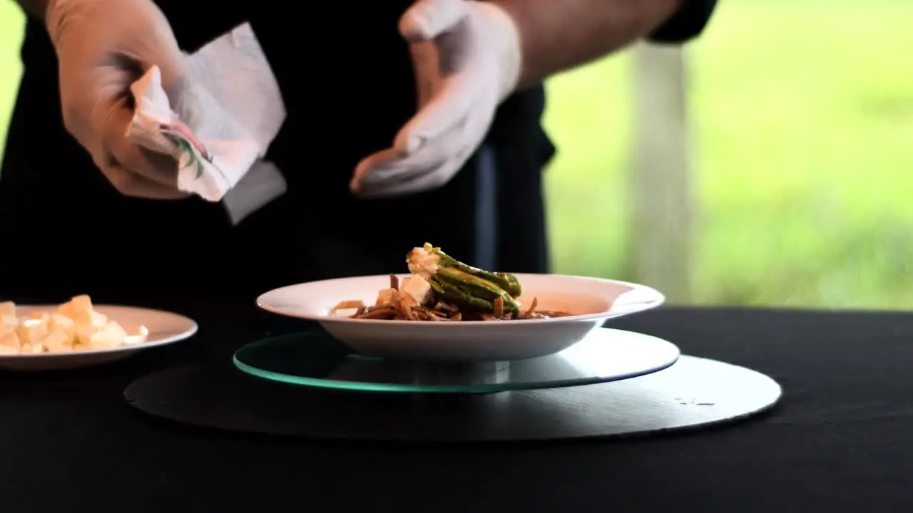 Hands cleaning a bowl with soup