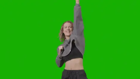 Studio Shot Of Young Woman Having Fun Dancing Against Green Screen 20