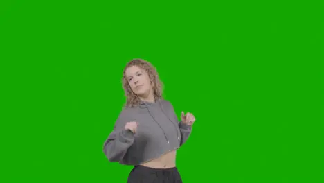 Studio Shot Of Young Woman Having Fun Dancing Against Green Screen 8