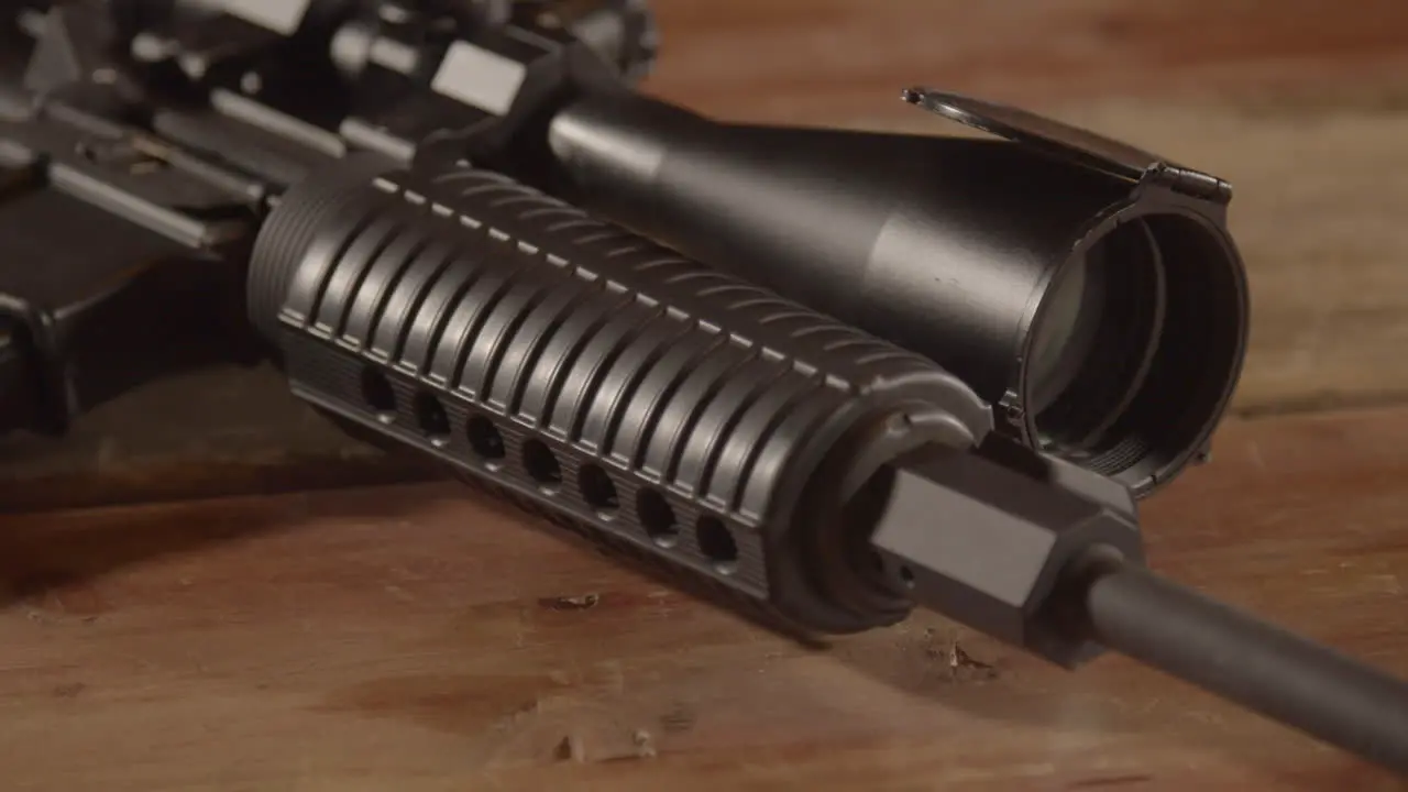 Close dolly of AR-15 handguard towards receiver