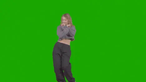 Studio Shot Of Young Woman Having Fun Dancing Against Green Screen 25