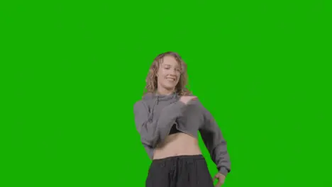 Studio Shot Of Young Woman Having Fun Dancing Against Green Screen 19