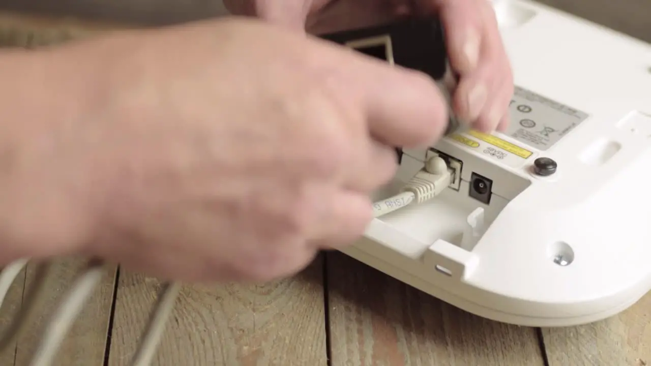 Network engineer fixing Ethernet cables between devices