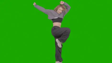 Studio Shot Of Young Woman Having Fun Dancing Against Green Screen 29