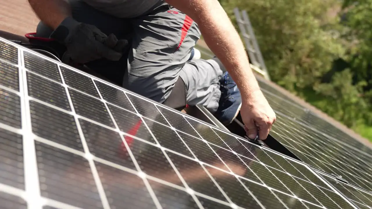 Solar panel installation by hand on civilians house sustainable energy