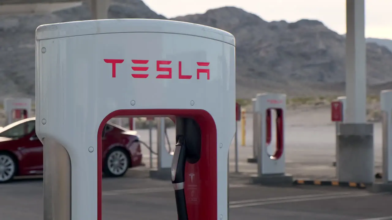 Red Tesla Charging At Supercharger