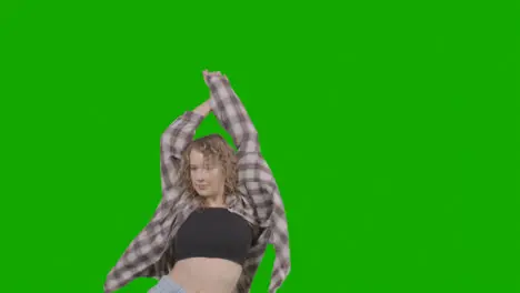 Studio Shot Of Young Woman Having Fun Dancing Against Green Screen 4