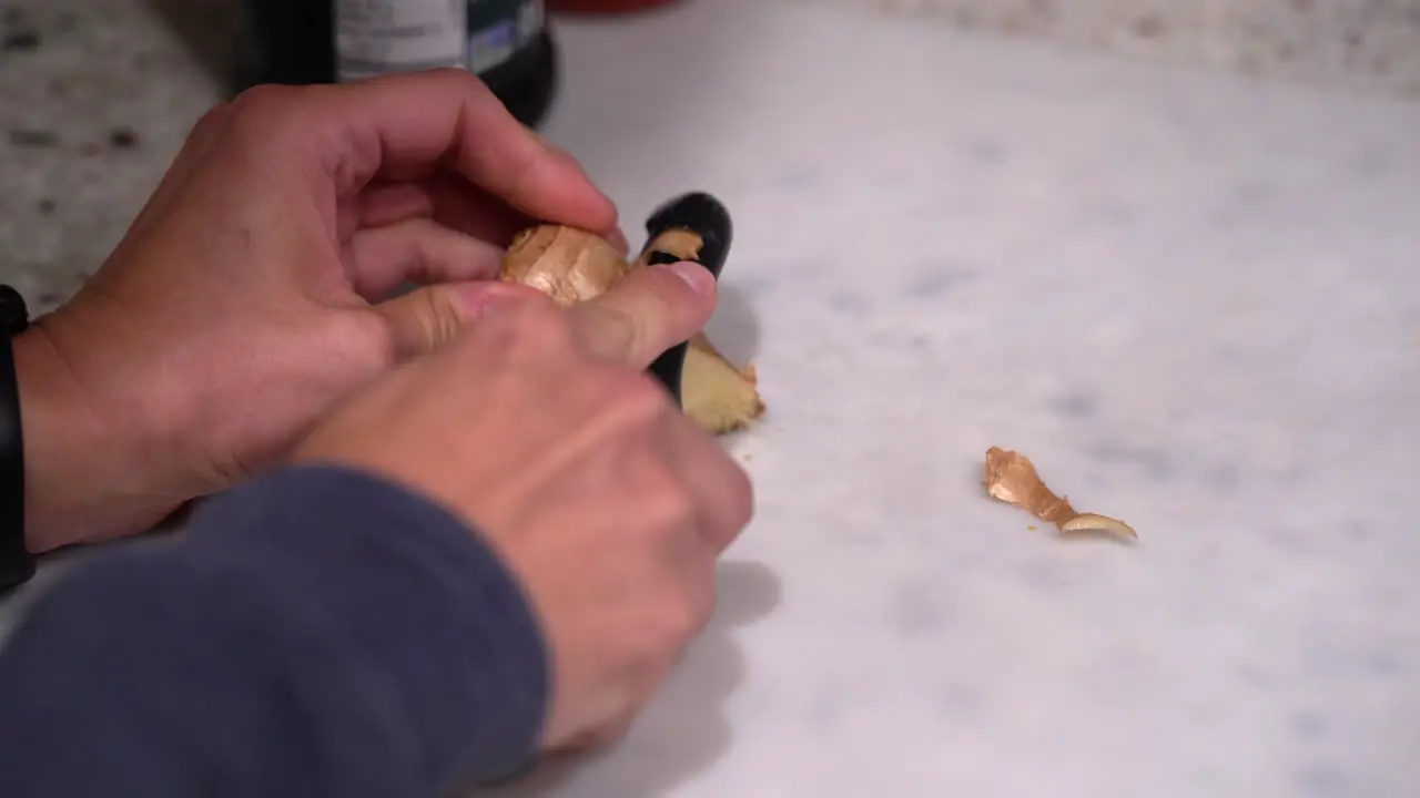 Cutting and peeling a fresh piece of ginger root