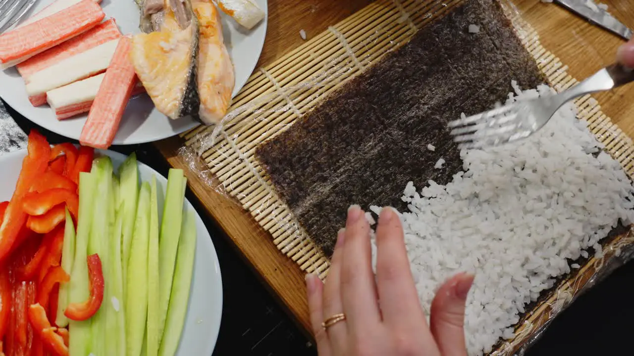 Lady Spreading Rice All Over With Fork Preparing Sushi Roll Homemade