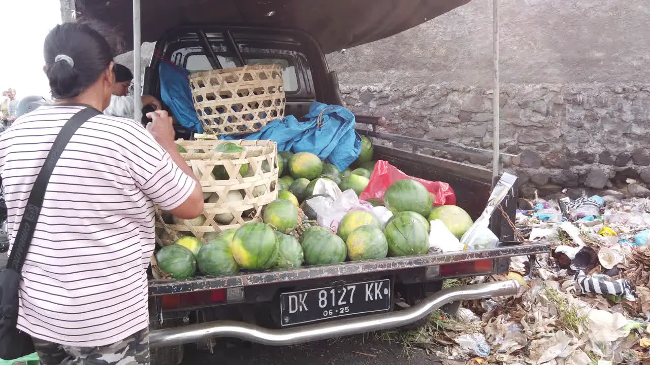 Woman Sells Watermelon Fruit in a Truck at Bali Indonesia Purnama Beach Sukawati Street Food Sell Fresh Fruits Offering Melons in The Back of a Pickup