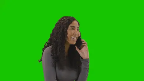 Frustrated Woman Talking On Mobile Phone Against Green Screen Before Hanging Up