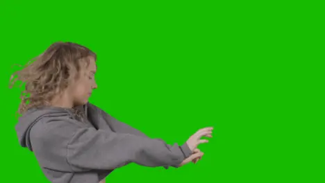 Studio Shot Of Young Woman Having Fun Dancing Against Green Screen 16