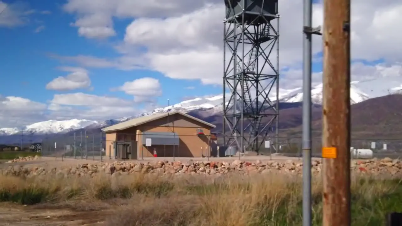 A hyper lapse driving up close to a radar tower in the middle of the country