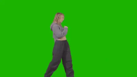 Full Length Studio Shot Of Young Woman Having Fun Dancing Against Green Screen 1