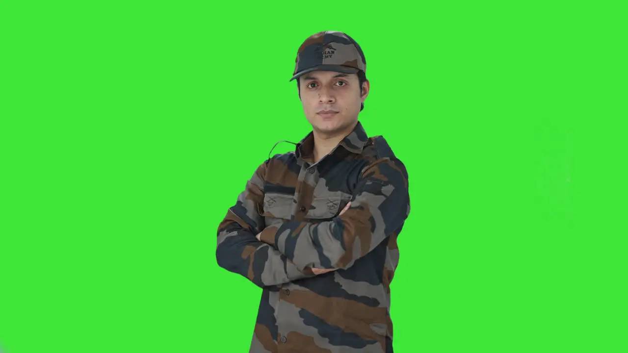 Portrait of Indian army man standing crossed hands Green screen