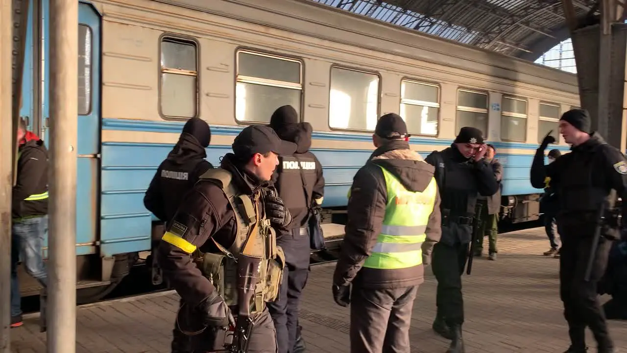 Soldiers and police guard the train station in Lviv Ukraine with refugees escaping the war with Russia