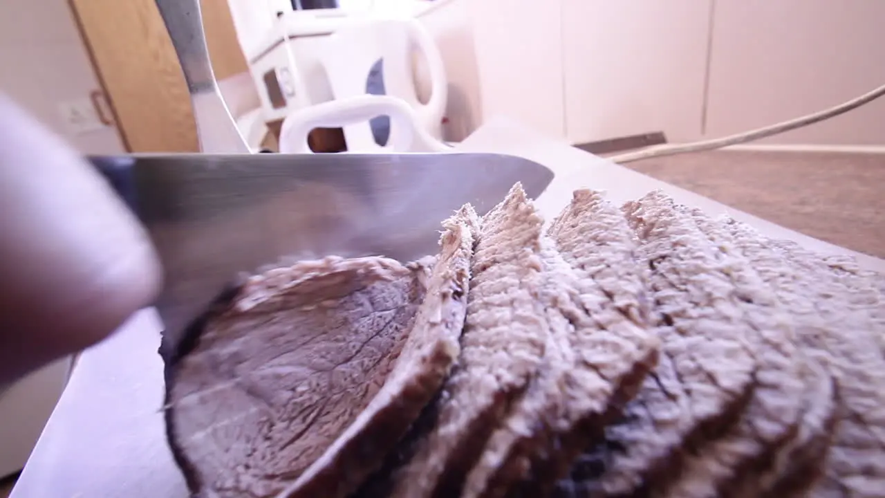 Cutting of some freshly roasted steamming hot roast beef