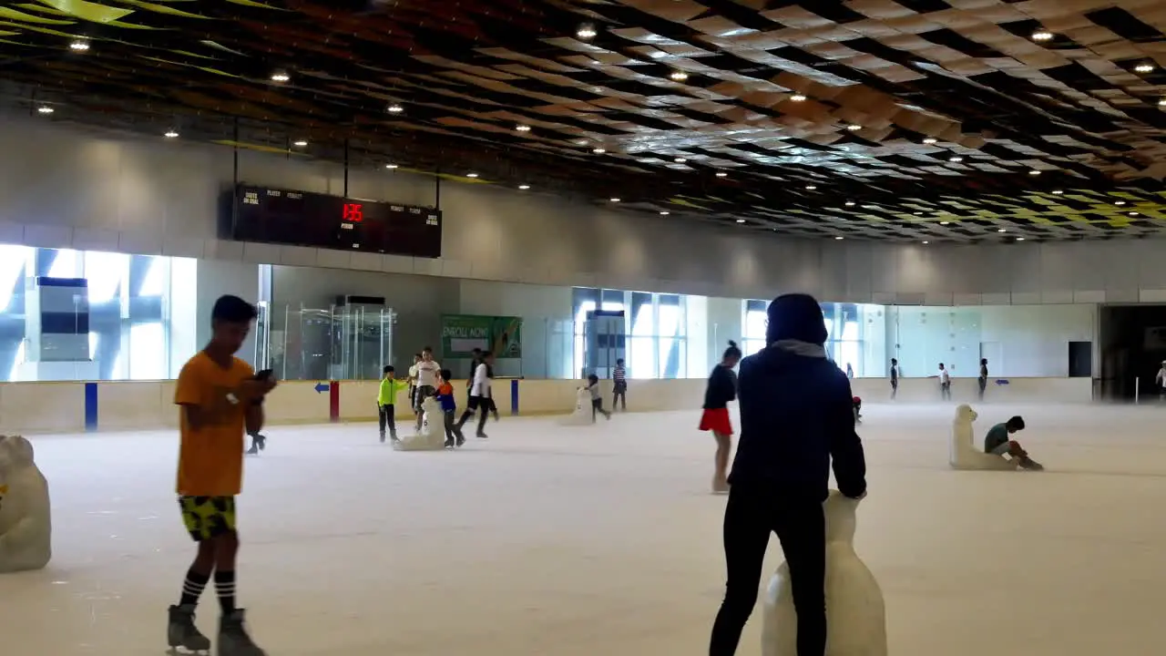 Filipino families enjoying the ice skating facilities within the SM Seaside Mall on South Road Properties Cebu City Philippines