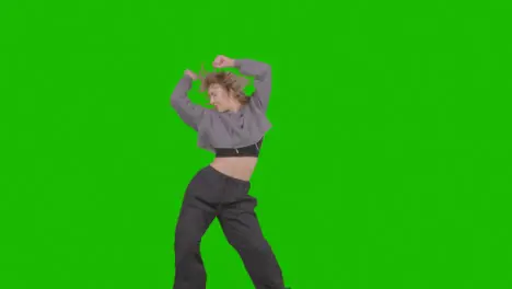 Studio Shot Of Young Woman Having Fun Dancing Against Green Screen 28