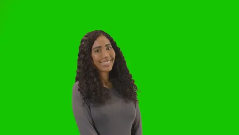 Portrait Of Woman Against Green Screen Smiling And Laughing At Camera