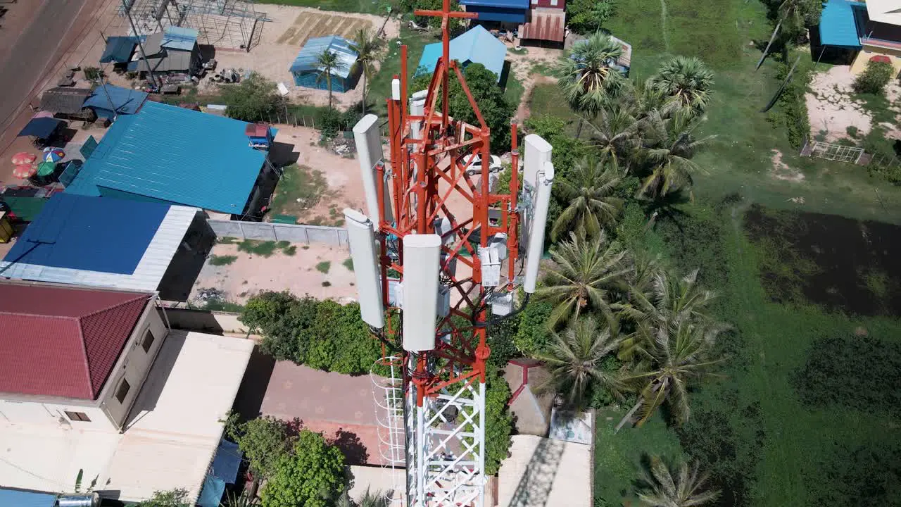 Cellular telecommunications mast sending connecting the world wide web against drone aerial pedestal tilt