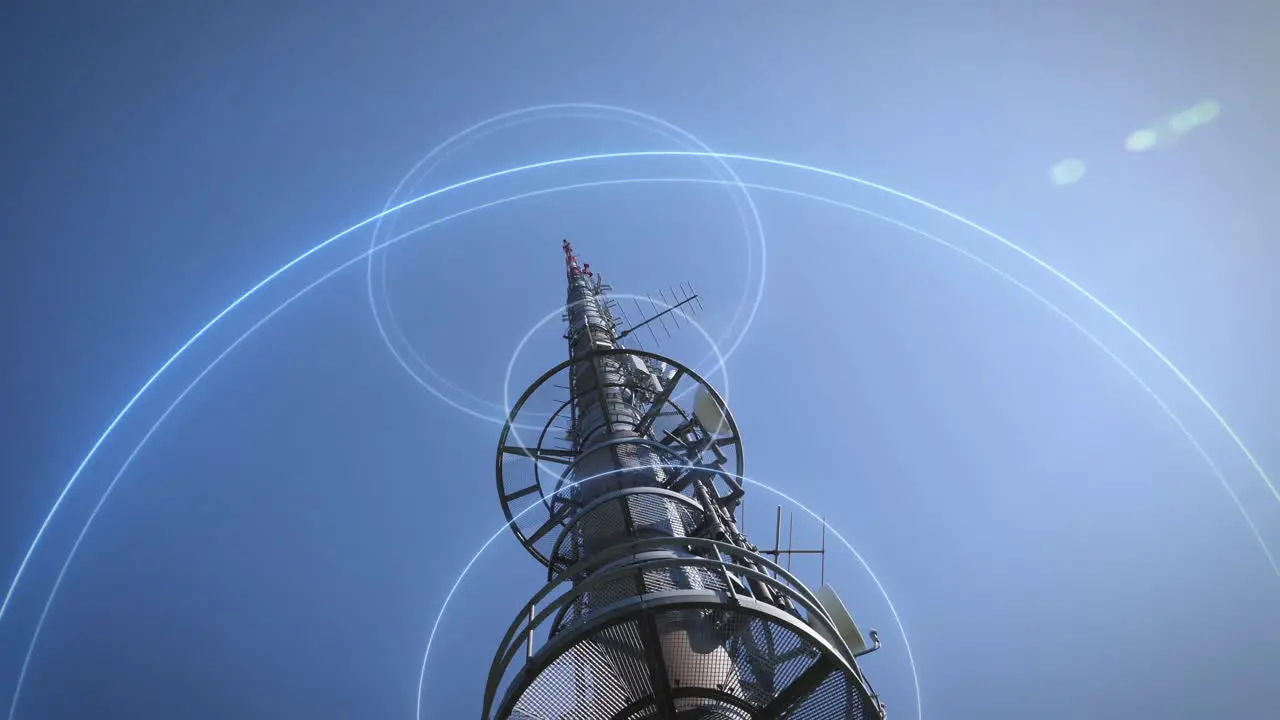 Low angle view of 5G communication mast against blue sky sends signal waves into the world