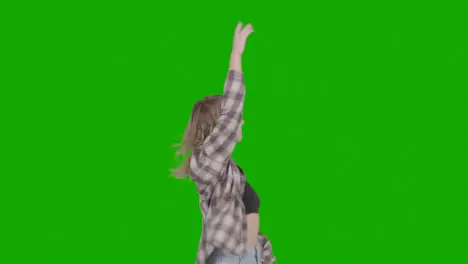 Studio Shot Of Young Woman Having Fun Dancing Against Green Screen 6