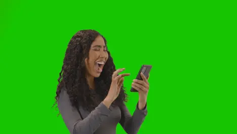 Woman Looking At Mobile Phone And Celebrating Good News Against Green Screen 3