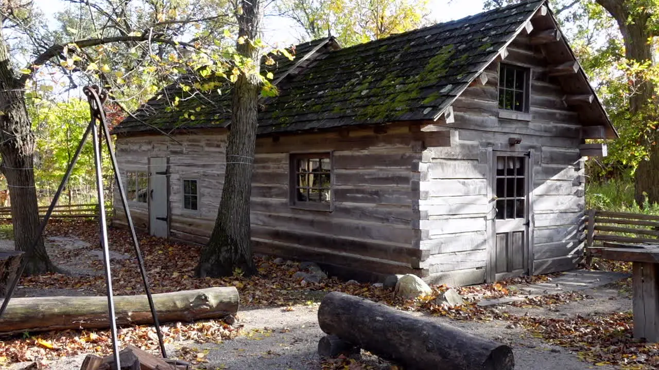 1800 Wood log cabin shining in the sun on an afternoon no person