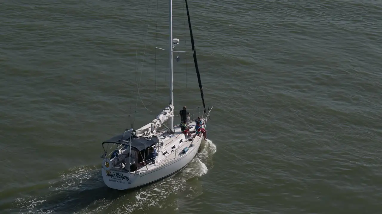 Top down view of a sailboat from the Kemah bridge heading out to Galveston Bay by Kemah Boardwalk in Kemah Texas