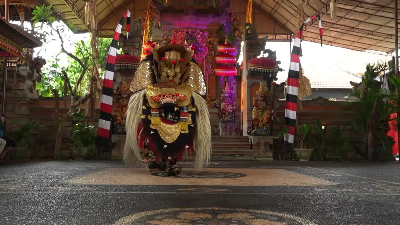 Traditional Balinese dance being performed in theatre with costumes near Ubud Indonesia depicting a dragon from Hindu religion