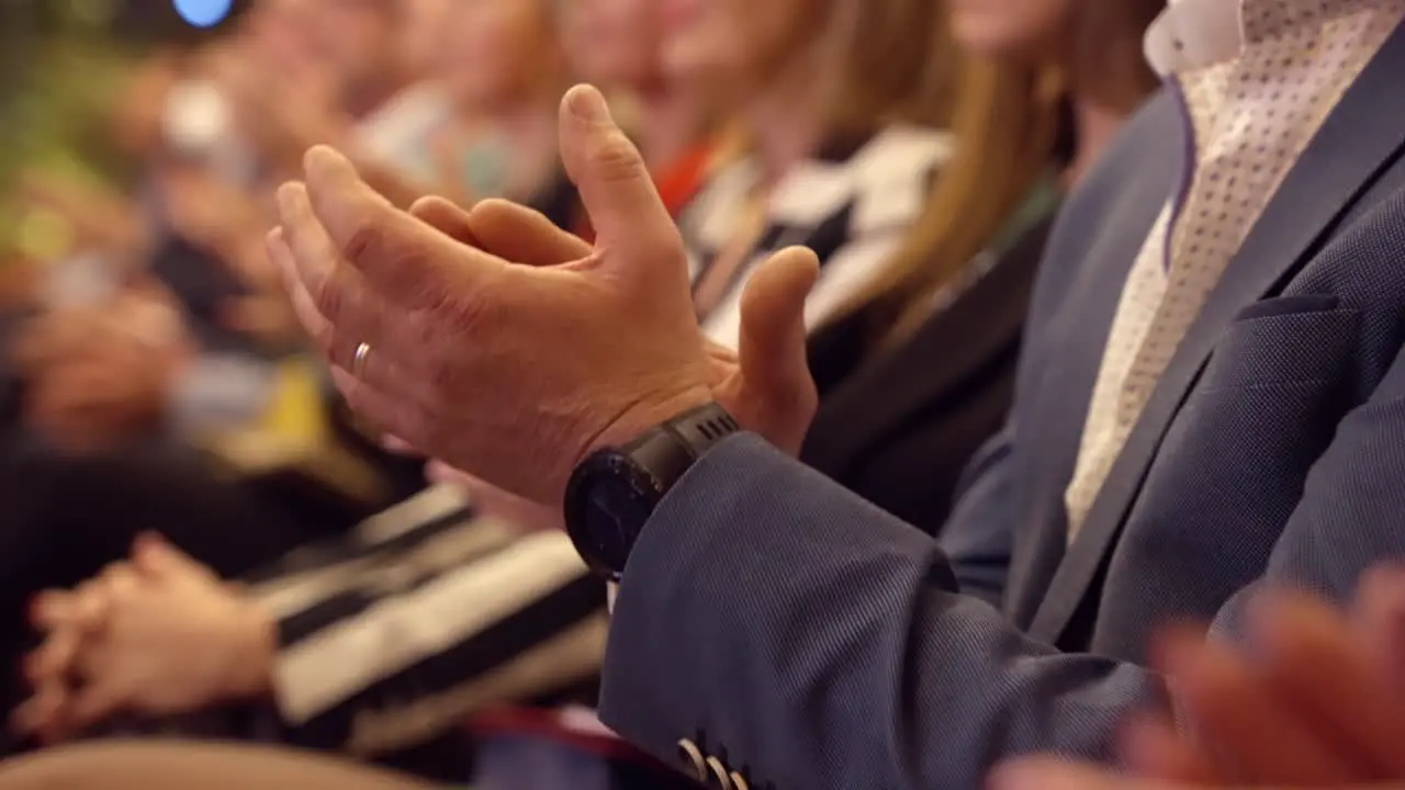 Man applauds at a business event